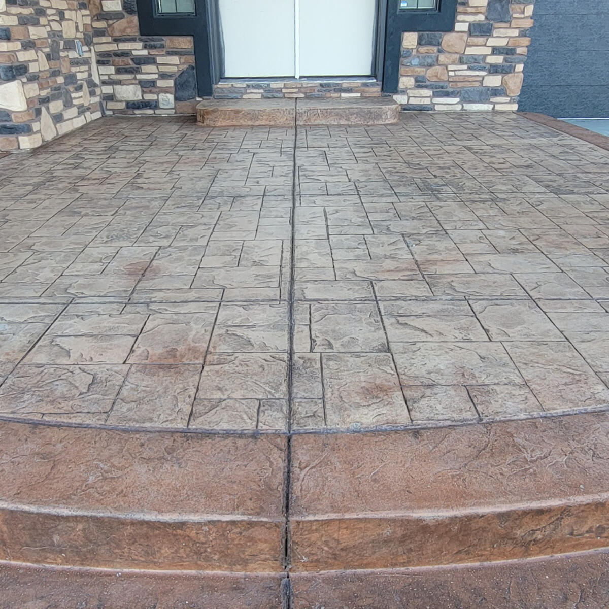 Decorative stamped concrete patio by Schroeder Construction LLC — Woodland Park Colorado